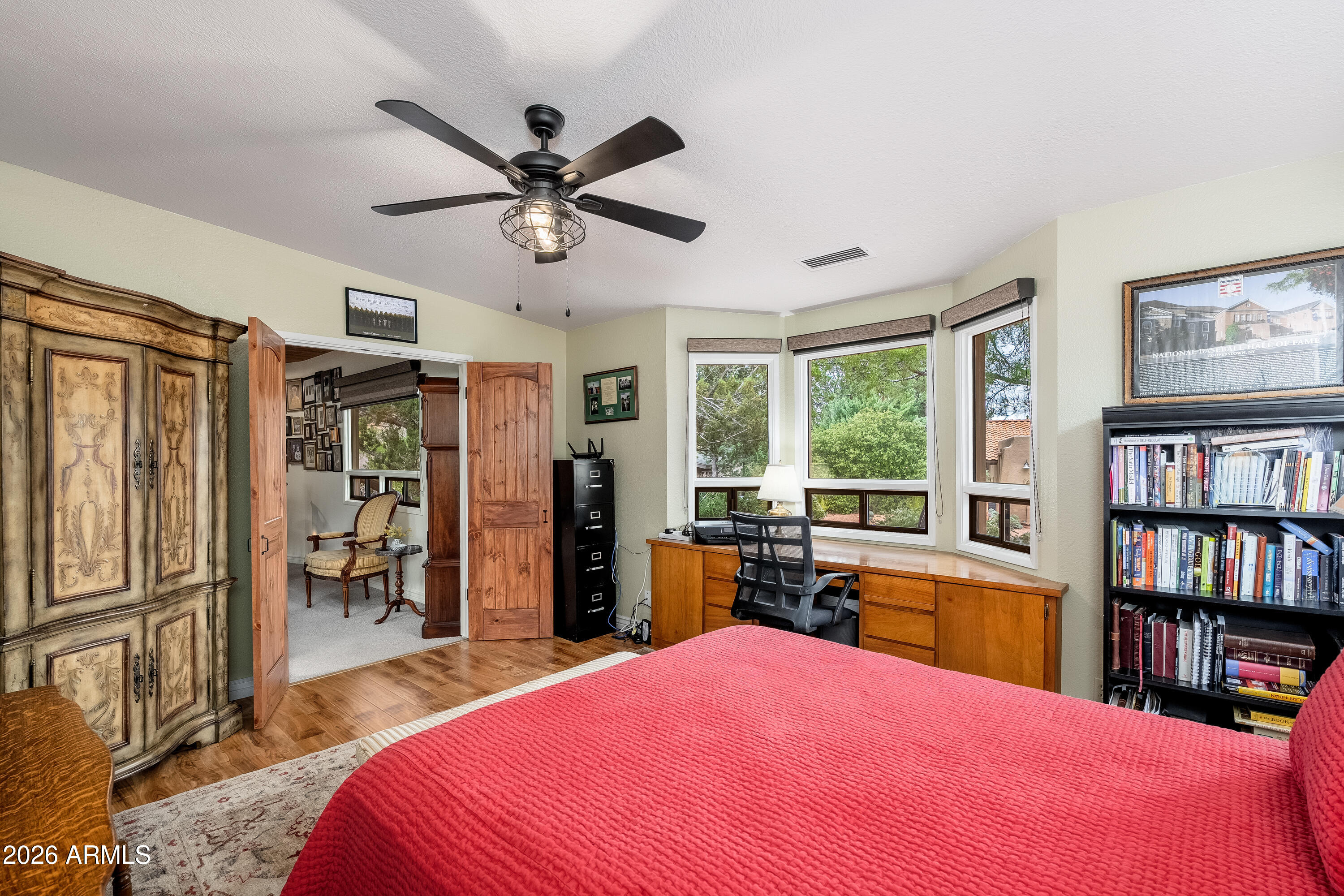 30 Kashmir Road Sedona, AZ 86336 - Photo 28 of 57 a bedroom with a bed a dresser and a book shelf