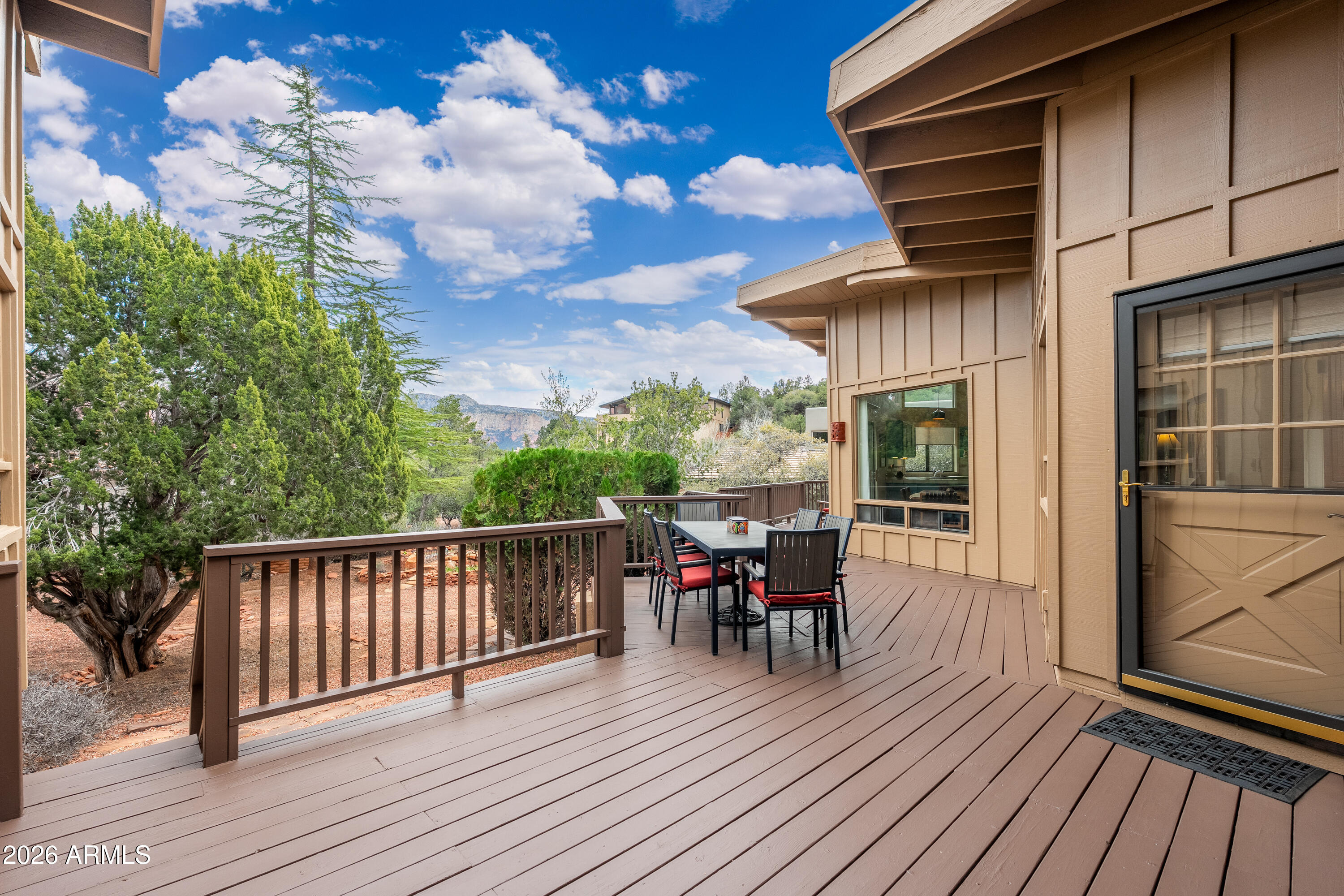 30 Kashmir Road Sedona, AZ 86336 - Photo 32 of 57 a view of a roof deck with table and chairs and wooden floor