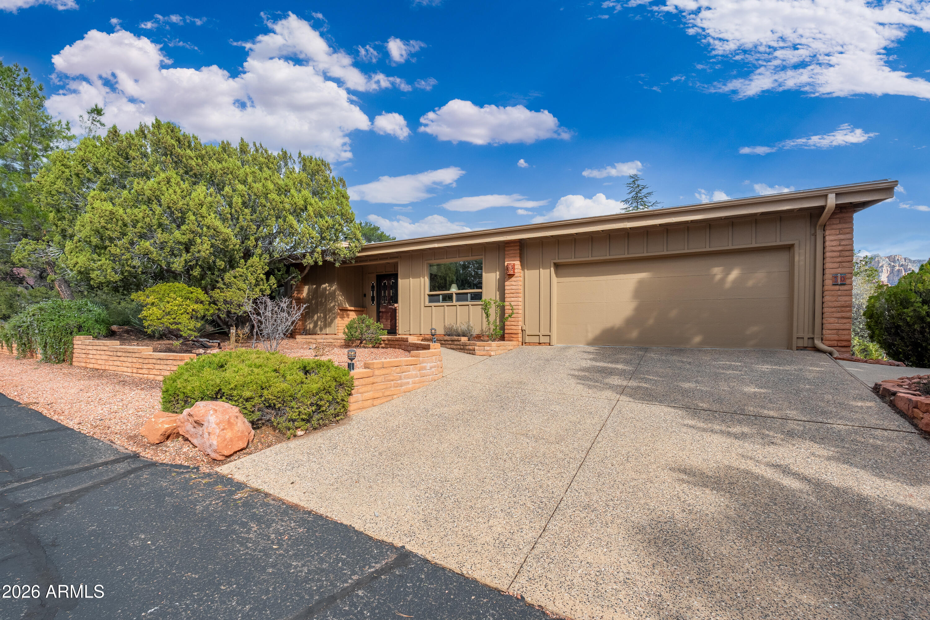30 Kashmir Road Sedona, AZ 86336 - Photo 3 of 57 a front view of a house with a yard and garage