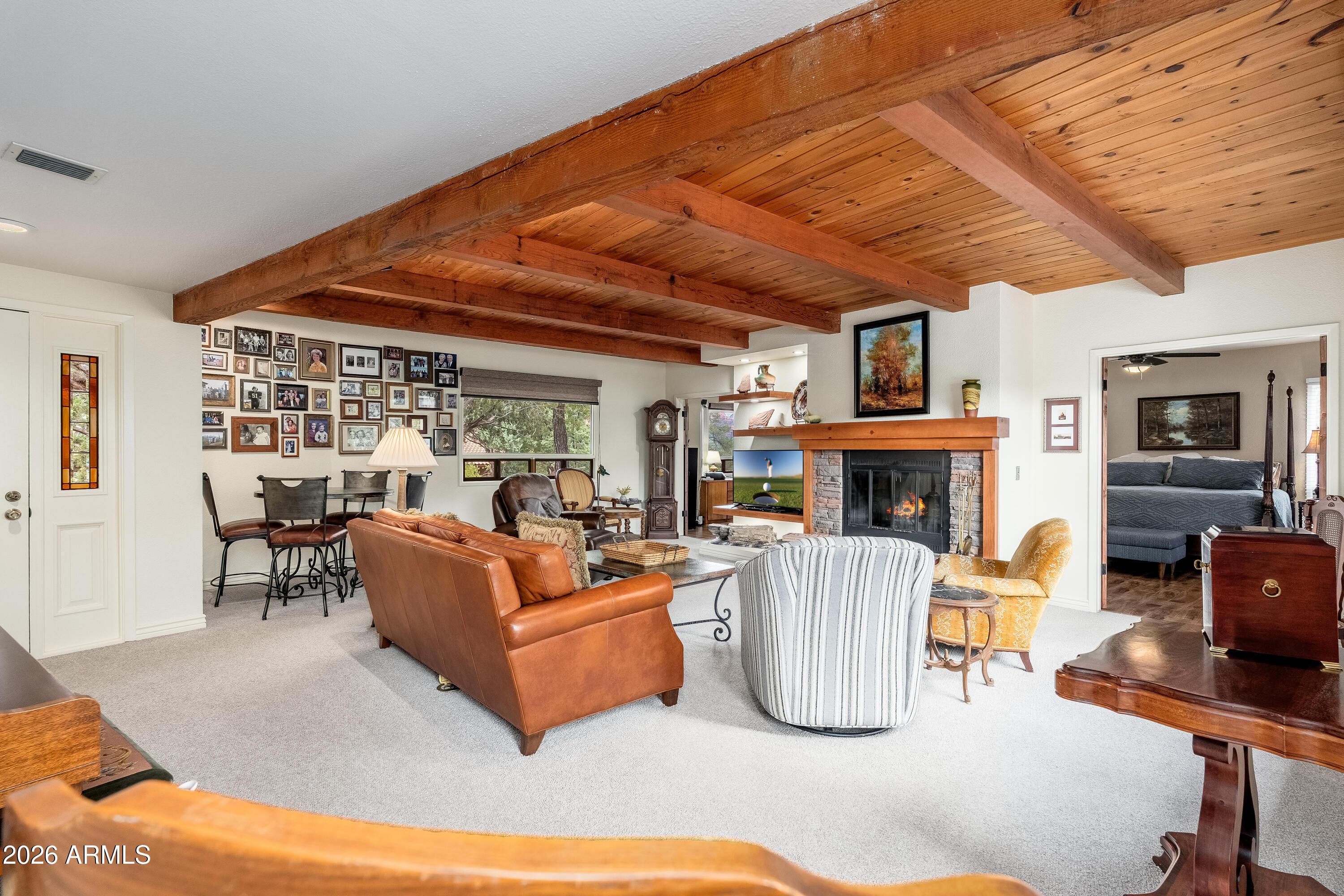 30 Kashmir Road Sedona, AZ 86336 - Photo 5 of 57 a living room with furniture a fireplace and a flat screen tv