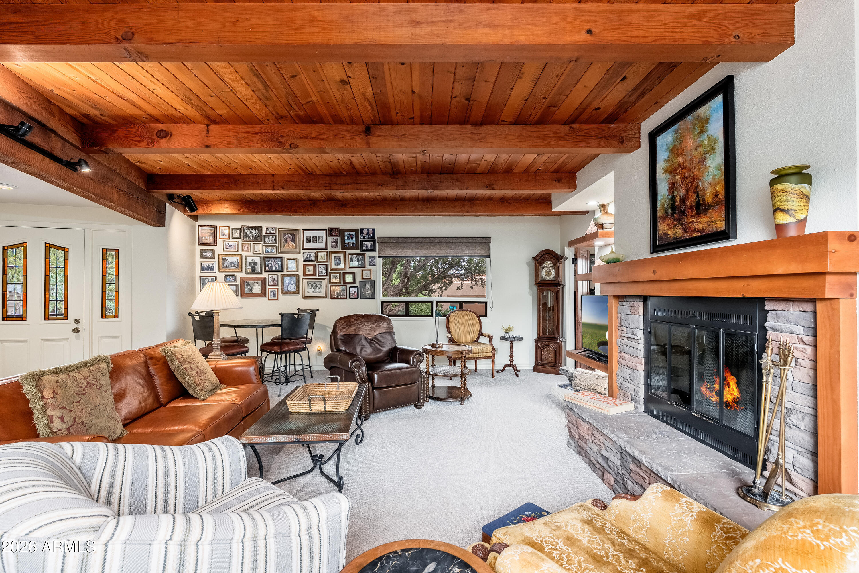 30 Kashmir Road Sedona, AZ 86336 - Photo 7 of 57 a living room with furniture a fireplace and a flat screen tv