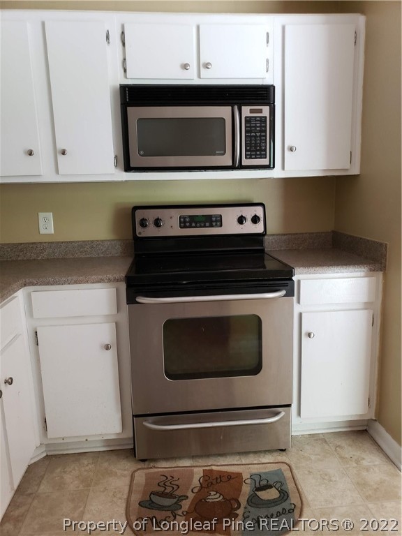 618 Pleasant Loop Fayetteville, NC 28311 - Photo 15 of 25 a kitchen with a stove and cabinets