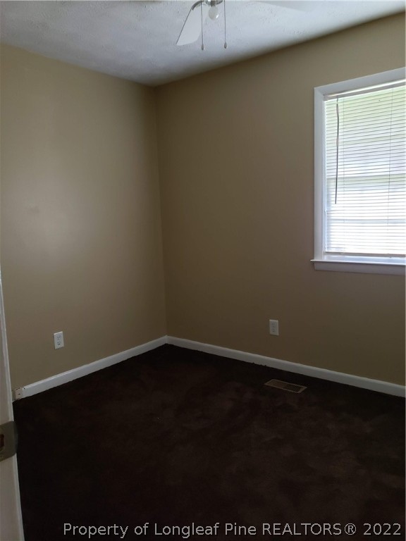 618 Pleasant Loop Fayetteville, NC 28311 - Photo 19 of 25 an empty room with a wooden floor and a window