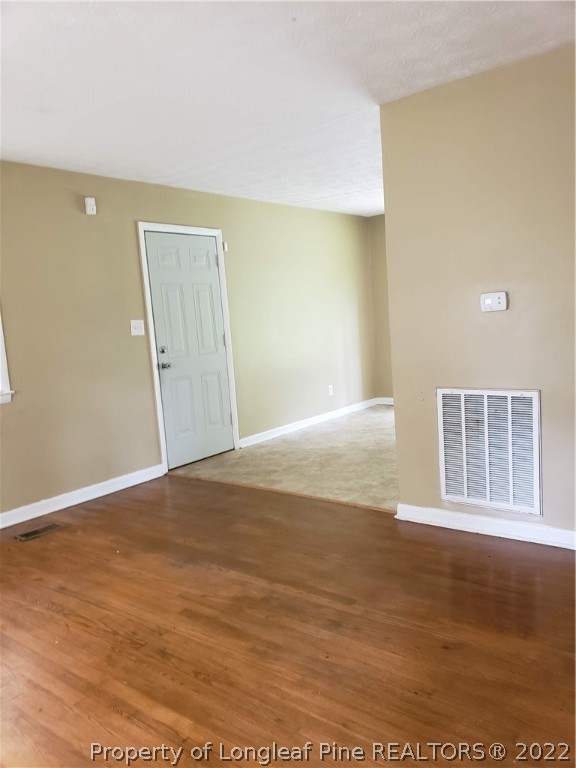 618 Pleasant Loop Fayetteville, NC 28311 - Photo 9 of 25 a view of empty room with wooden floor and fan