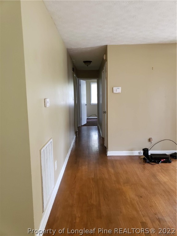 618 Pleasant Loop Fayetteville, NC 28311 - Photo 10 of 25 a view of a hallway with wooden floor