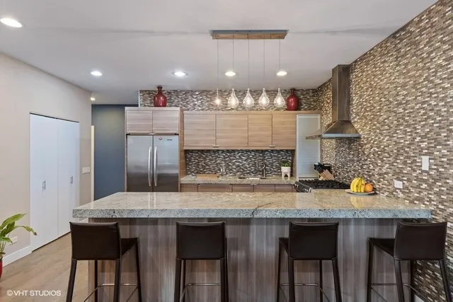 a kitchen with a wooden table and chairs