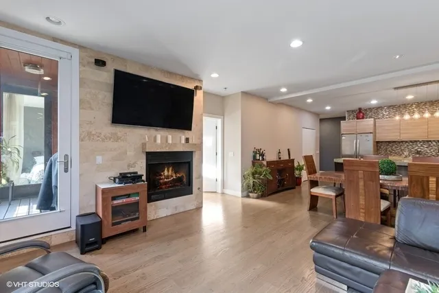 a living room with furniture fireplace and flat screen tv