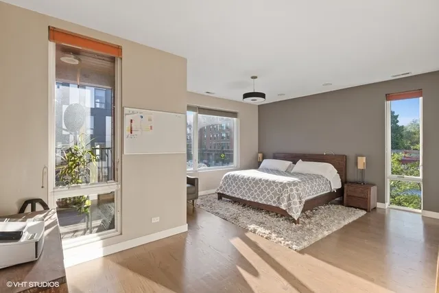 a bedroom with a bed a mirror and a window