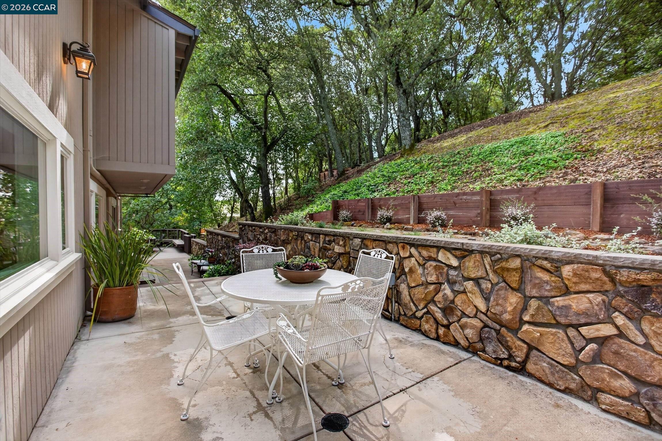 4105 Coralee Lane Lafayette, CA 94549 - Photo 20 of 43 a view of a patio with table and chairs potted plants with wooden fence