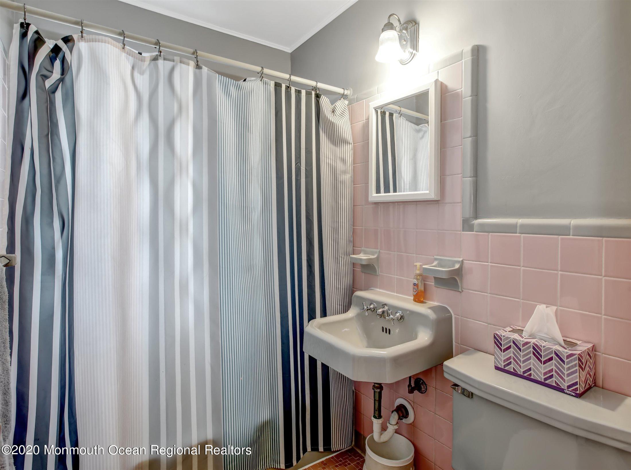 515 Couse Road Neptune Township, NJ 07753 - Photo 13 of 26 a bathroom with a sink a toilet and shower curtain
