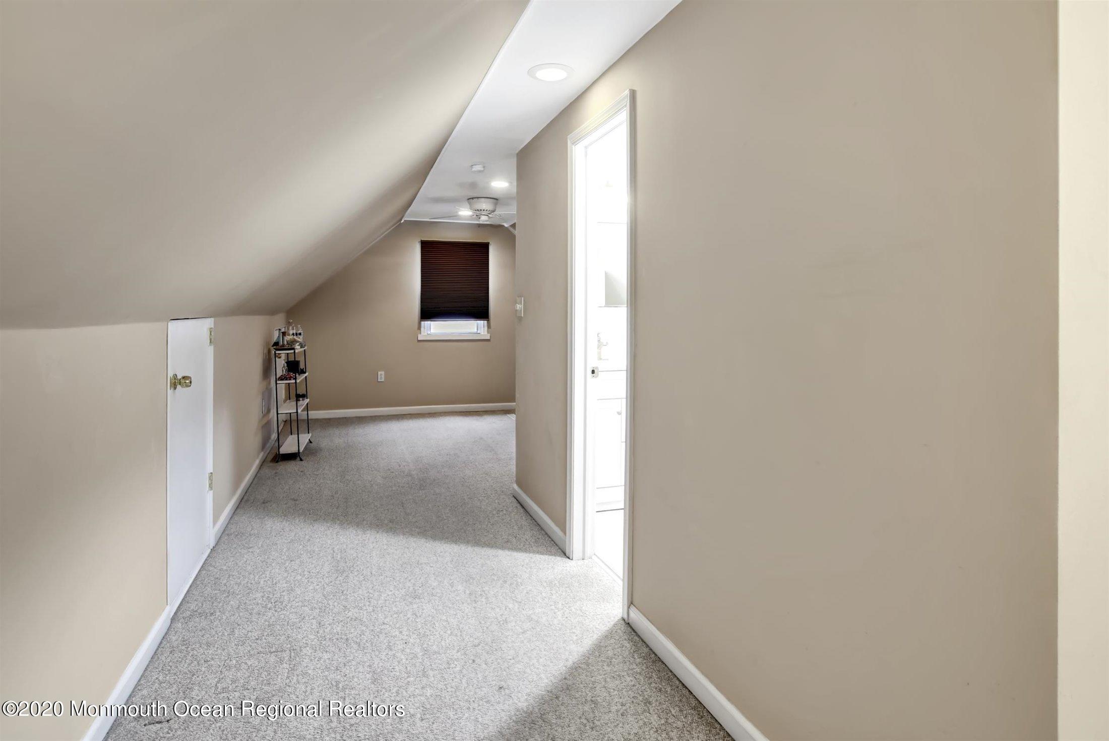 515 Couse Road Neptune Township, NJ 07753 - Photo 16 of 26 a view of a hallway with white walls and stairs