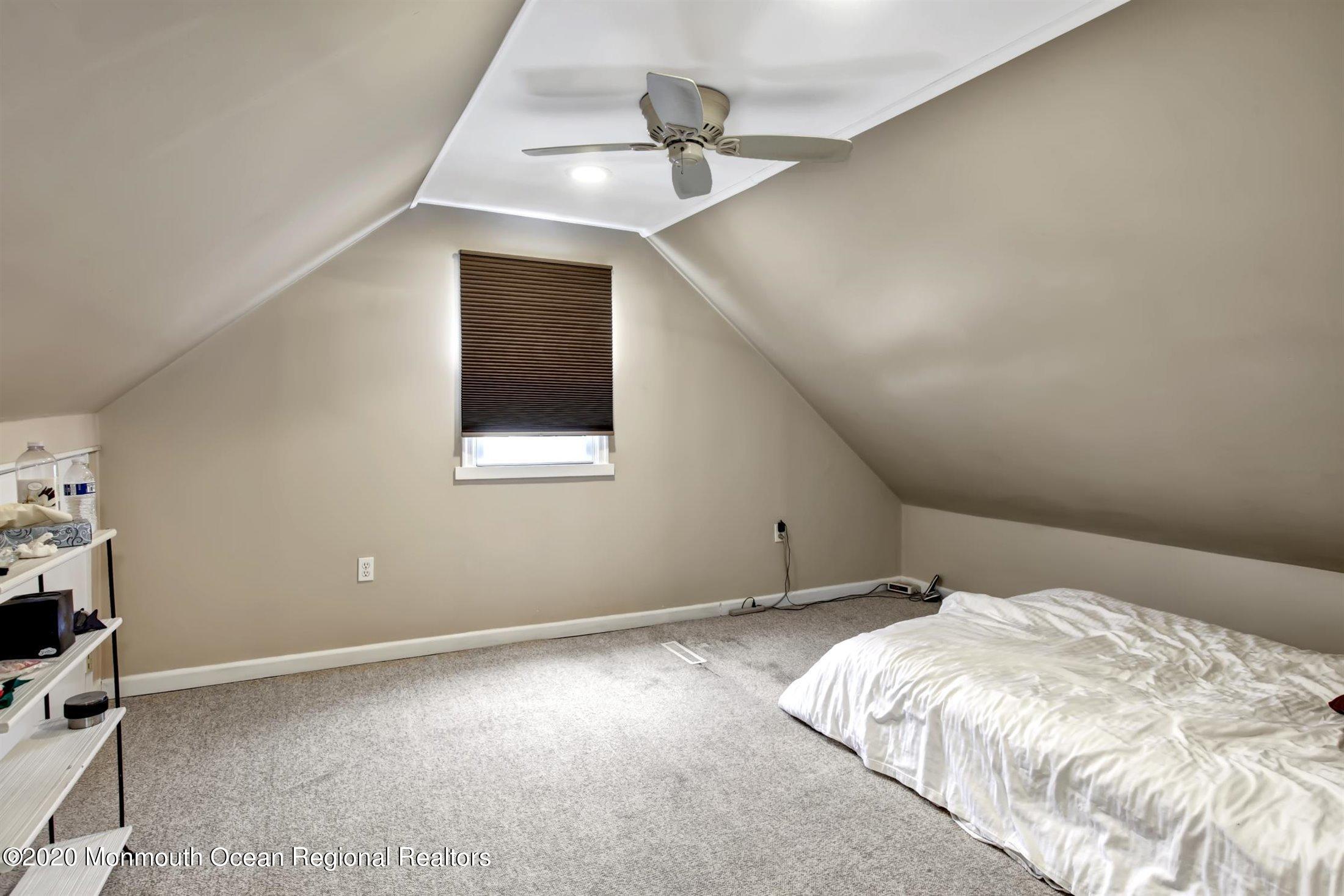515 Couse Road Neptune Township, NJ 07753 - Photo 17 of 26 a bedroom with a bed and a ceiling fan