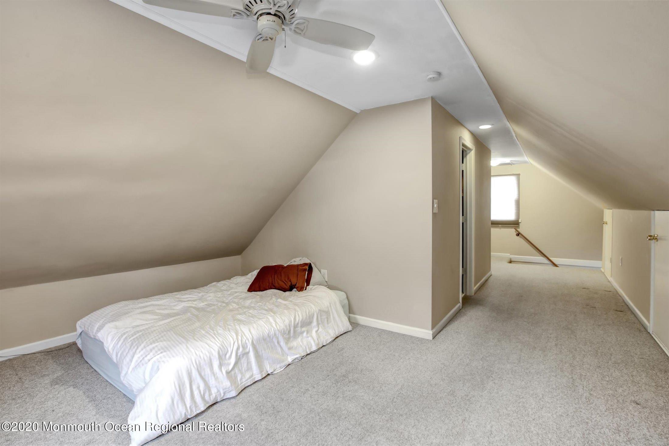 515 Couse Road Neptune Township, NJ 07753 - Photo 18 of 26 a bedroom with a bed and chandelier