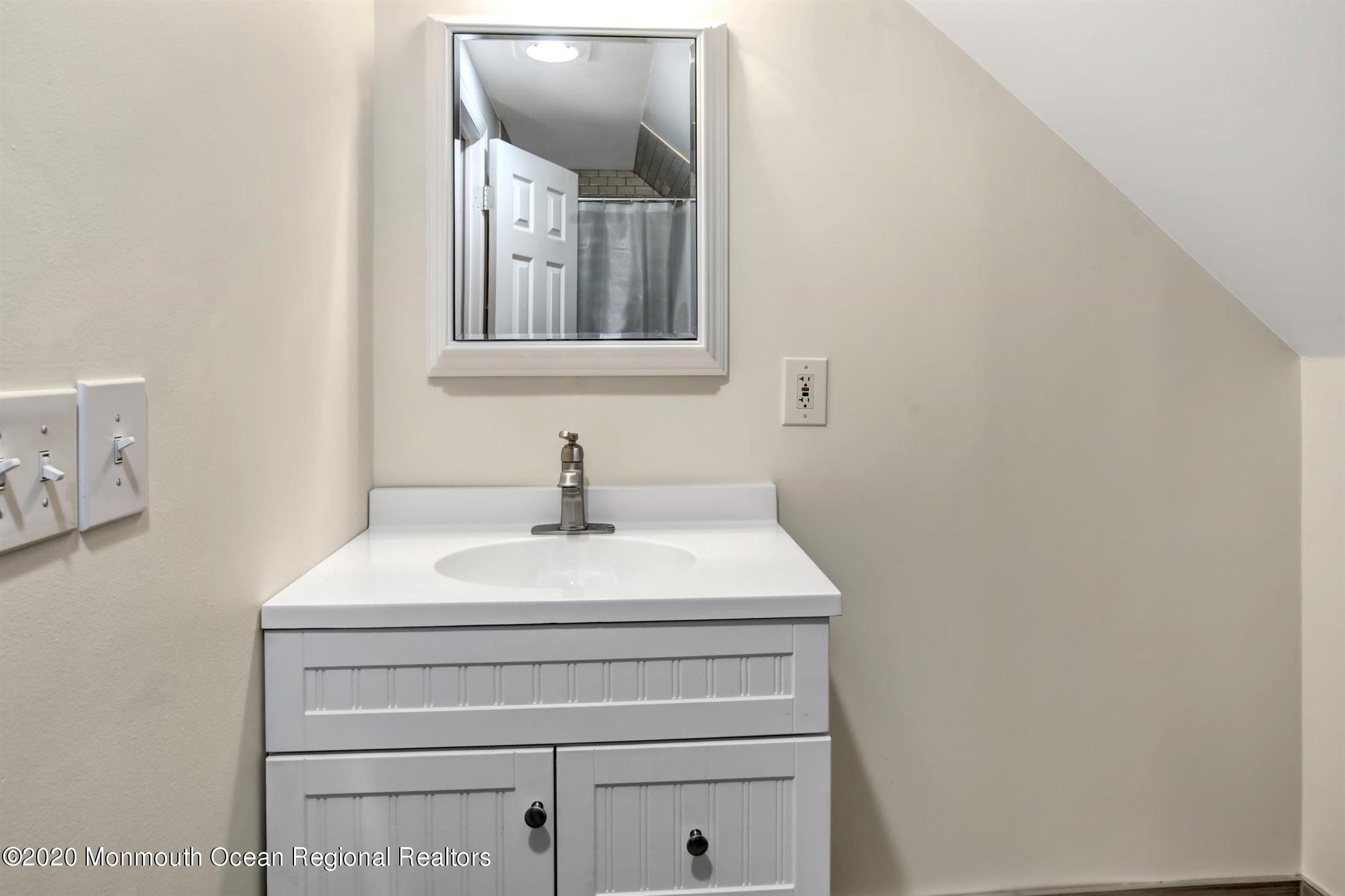 515 Couse Road Neptune Township, NJ 07753 - Photo 19 of 26 a bathroom with a sink and a mirror