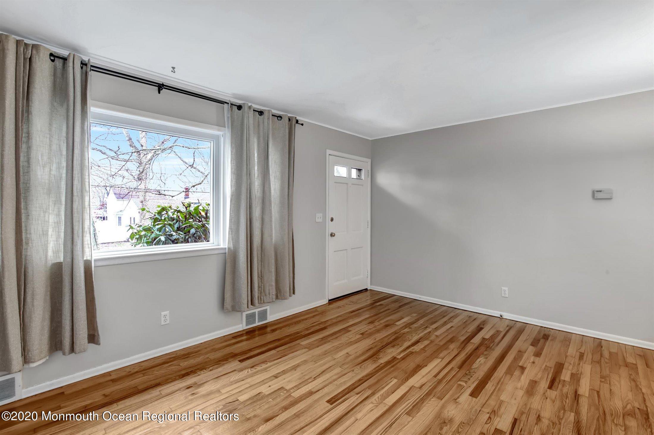 515 Couse Road Neptune Township, NJ 07753 - Photo 6 of 26 a view of a big room with wooden floor and windows