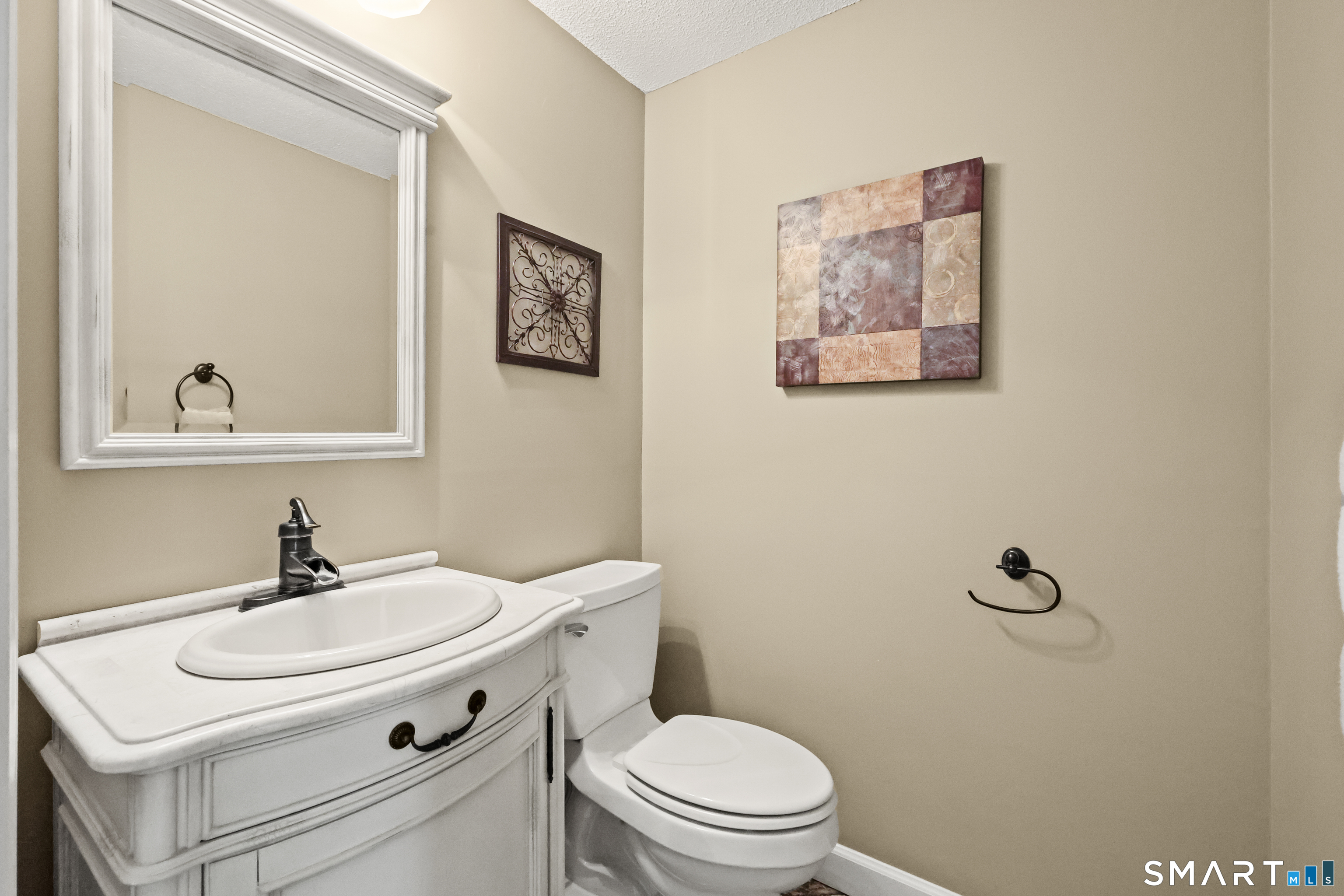 17 Briar Hill Road Avon, CT 06001 - Photo 14 of 38 Main floor half bath has a wider door for accessible access. Very warm colors and travertine flooring.