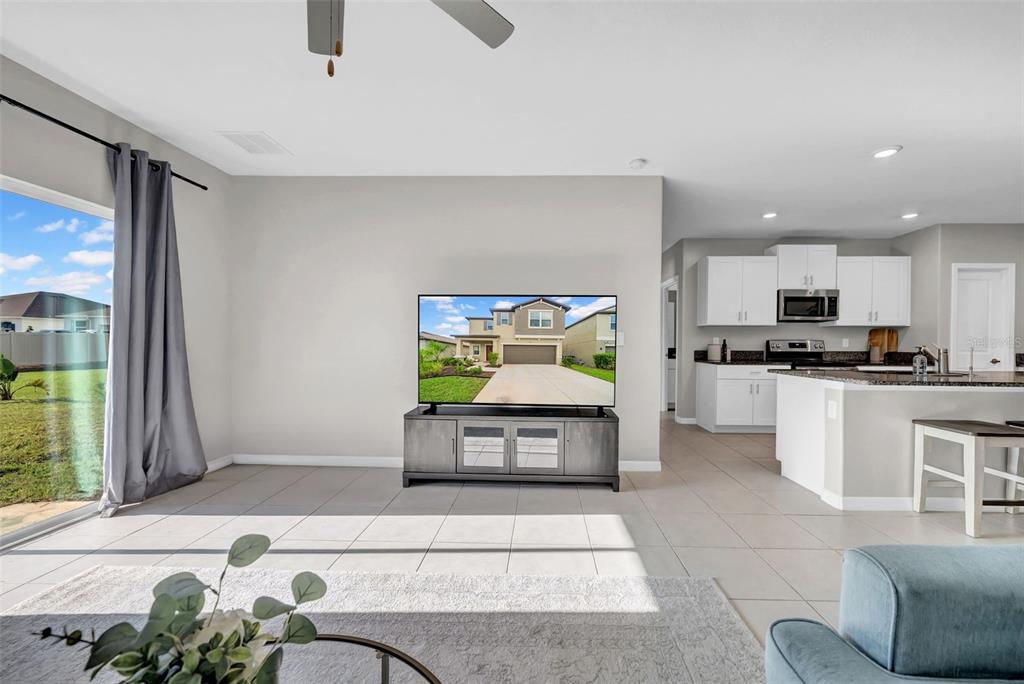 31440 Barrel Wave Way Wesley Chapel, FL 33545 - Photo 17 of 73 a kitchen with stainless steel appliances kitchen island granite countertop a sink and a counter top space