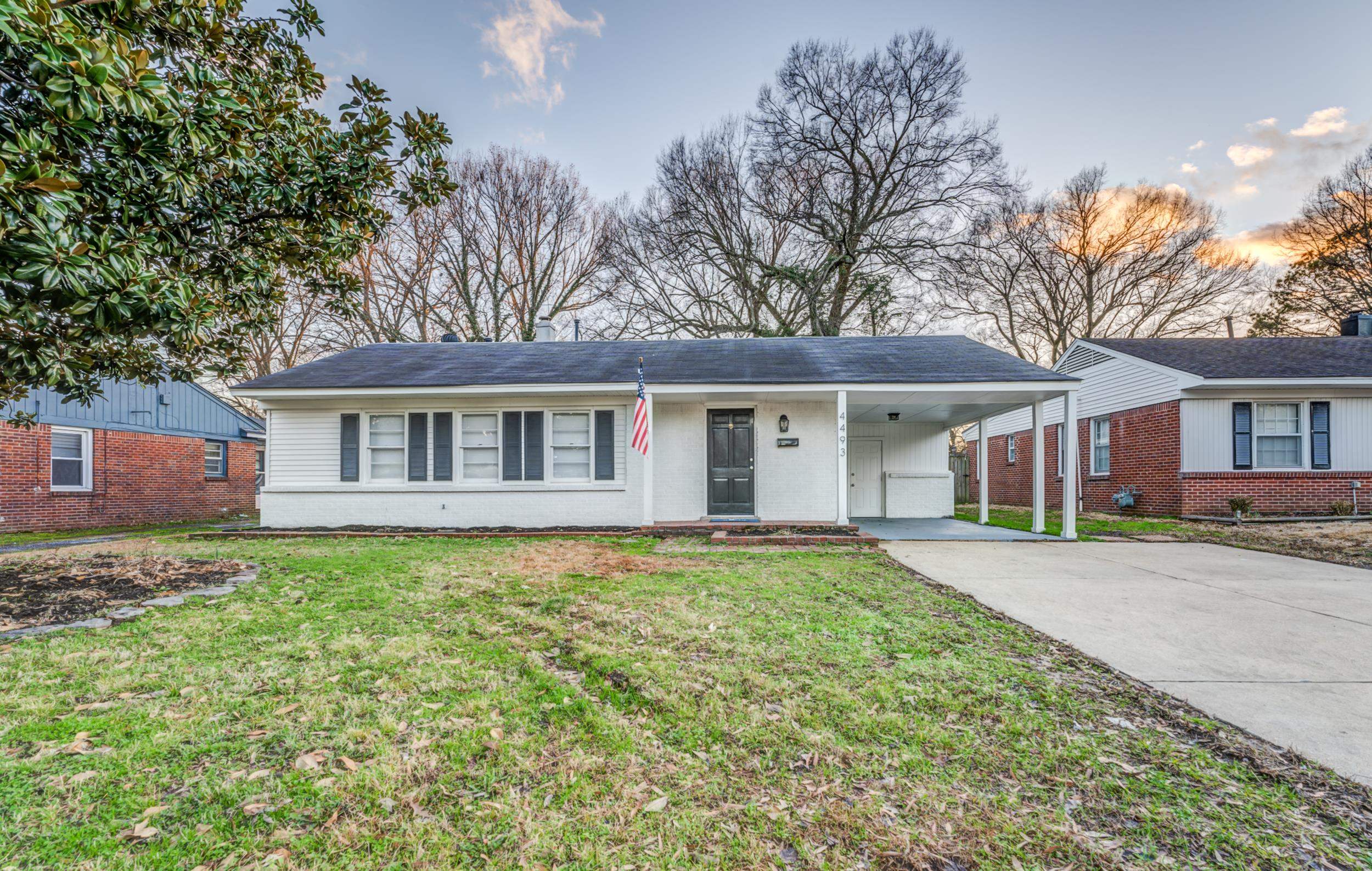 4493 Quince Road Memphis, TN 38117 - Photo 1 of 22 a front view of a house with a garden