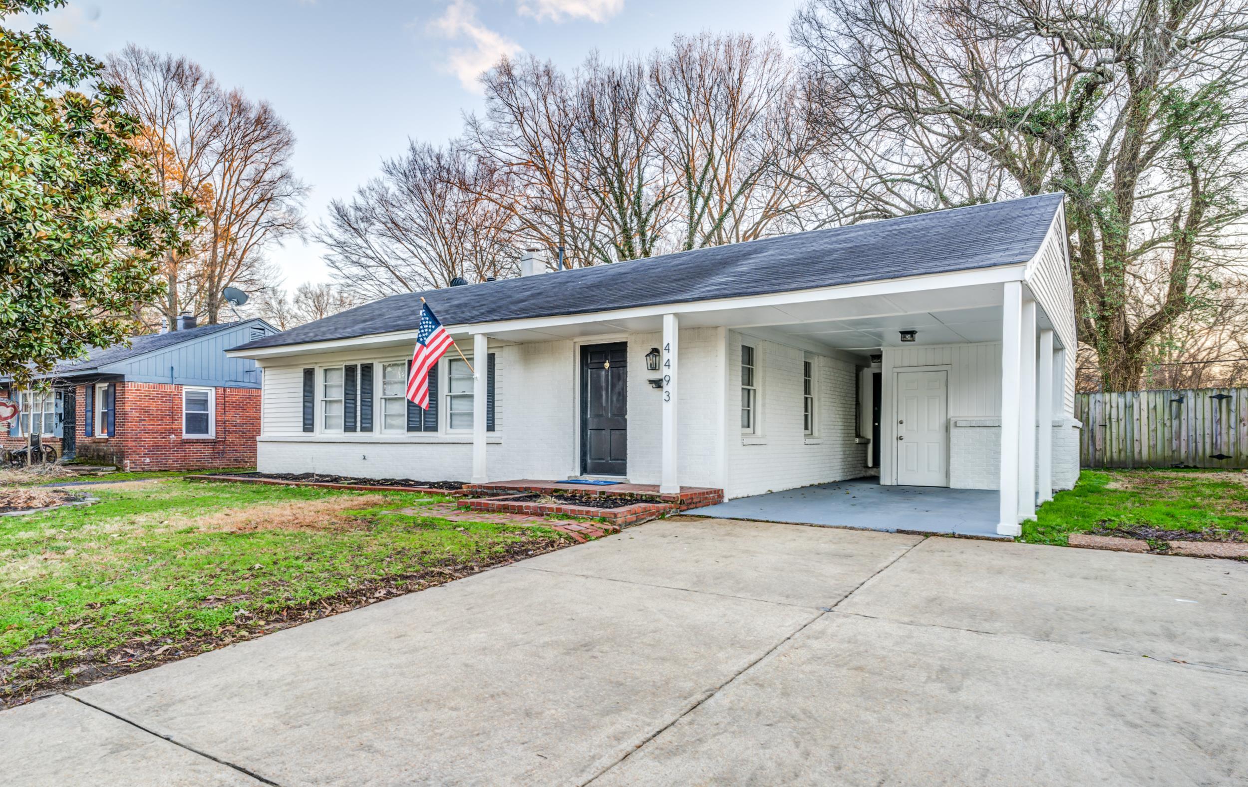 4493 Quince Road Memphis, TN 38117 - Photo 2 of 22 a front view of house with yard and green space