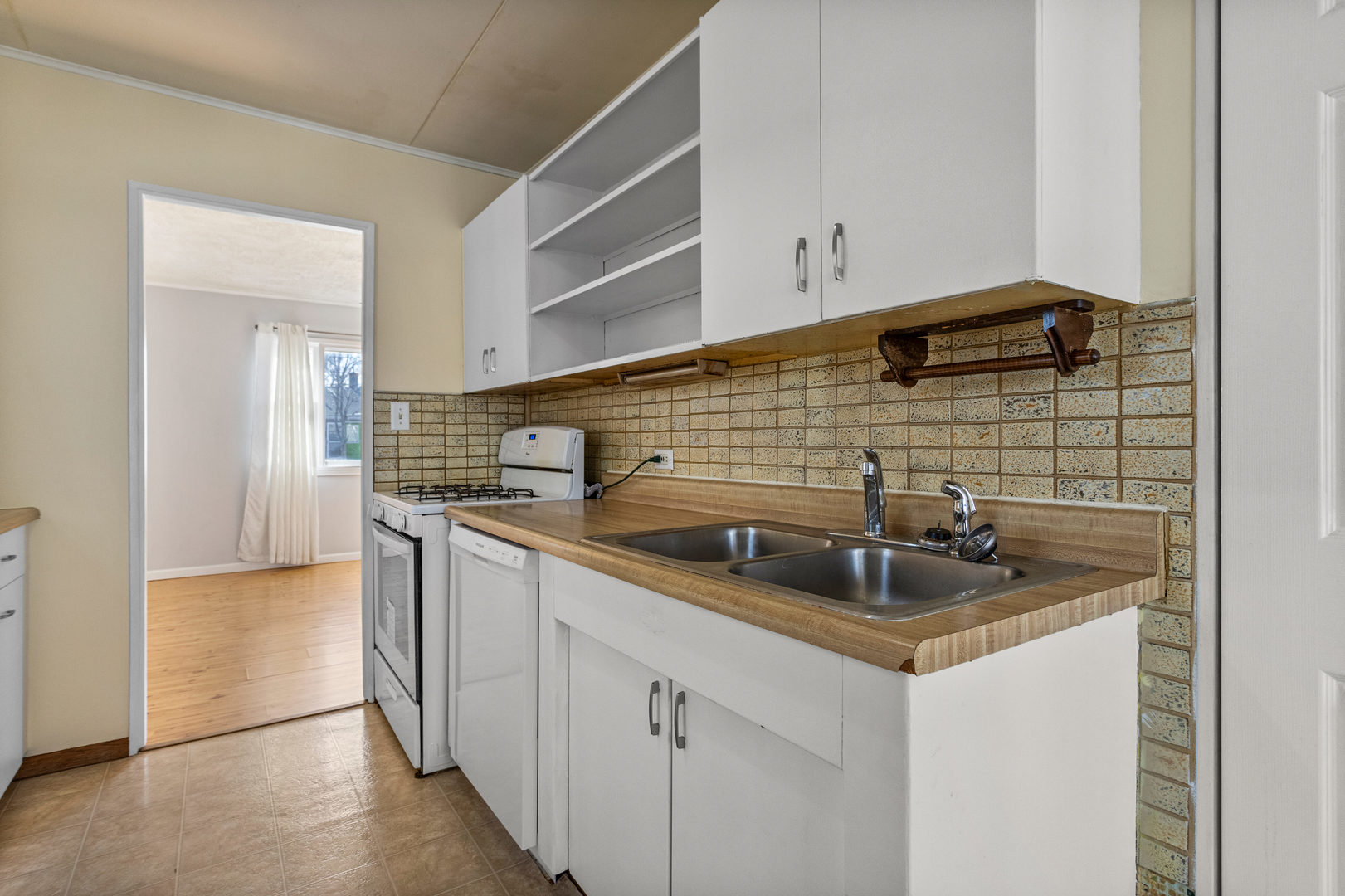 408 Maizefield Avenue Bloomington, IL 61701 - Photo 11 of 28 a kitchen with stainless steel appliances granite countertop a sink stove and cabinets