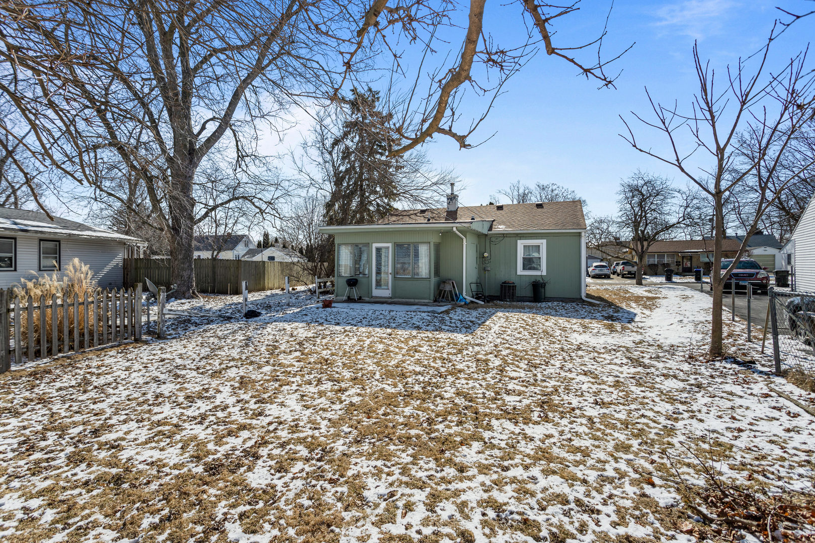 408 Maizefield Avenue Bloomington, IL 61701 - Photo 26 of 28 a view of a house with a yard covered in snow