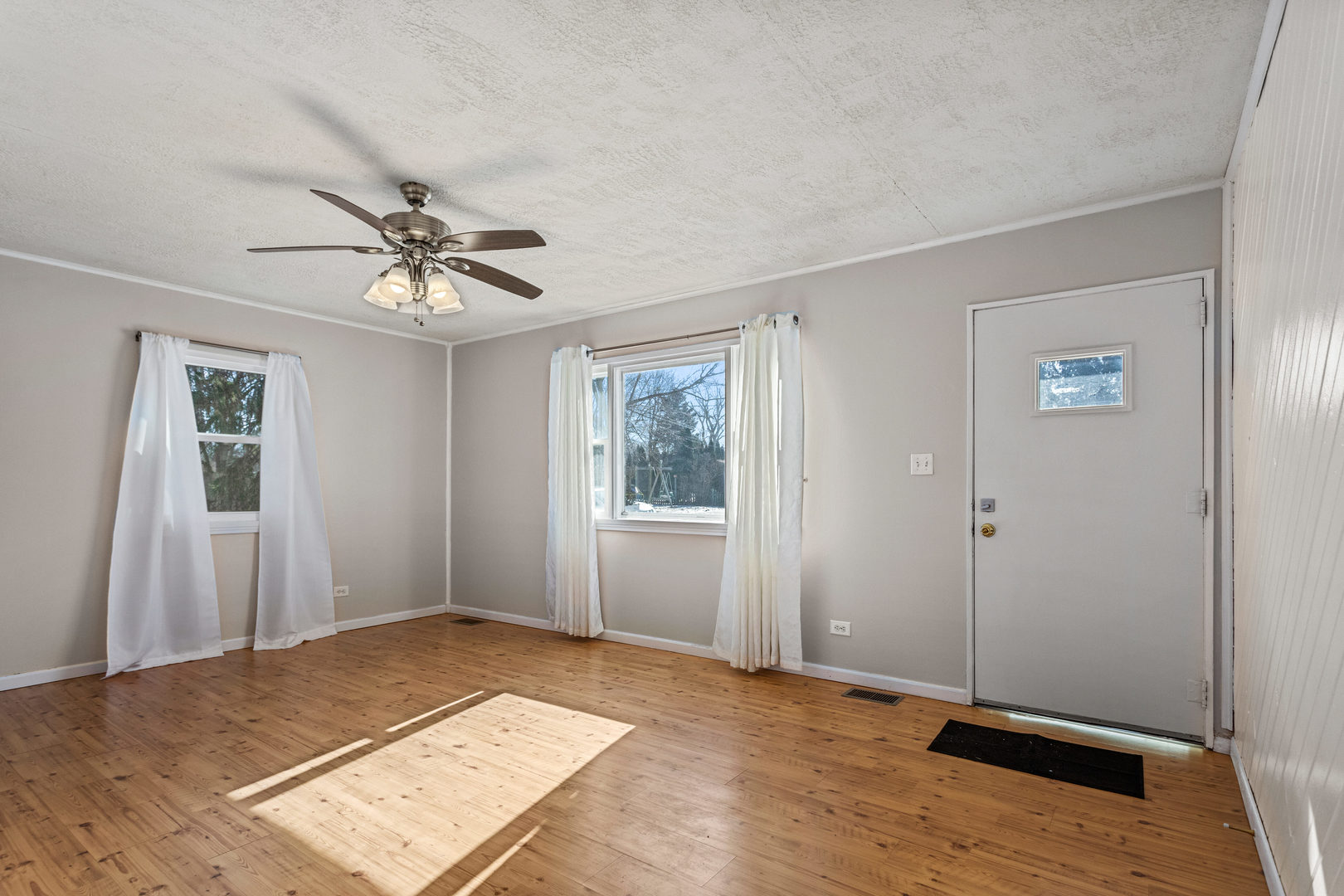 408 Maizefield Avenue Bloomington, IL 61701 - Photo 6 of 28 a view of an empty room with window and wooden floor