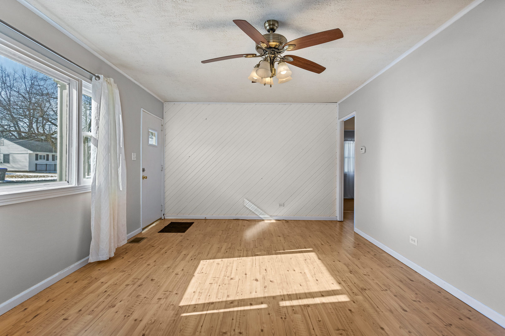 408 Maizefield Avenue Bloomington, IL 61701 - Photo 7 of 28 an empty room with wooden floor and windows