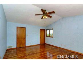 238 Gouges Branch Road Leicester, NC 28748 - Photo 12 of 23 a view of empty room with wooden floor and fan