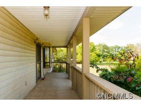 238 Gouges Branch Road Leicester, NC 28748 - Photo 18 of 23 a view of a porch with wooden floor and outdoor seating