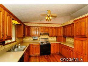 238 Gouges Branch Road Leicester, NC 28748 - Photo 6 of 23 a kitchen with kitchen island granite countertop a sink stainless steel appliances and cabinets