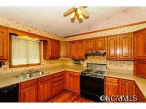 238 Gouges Branch Road Leicester, NC 28748 - Photo 7 of 23 a kitchen with stainless steel appliances granite countertop a stove a sink and a microwave