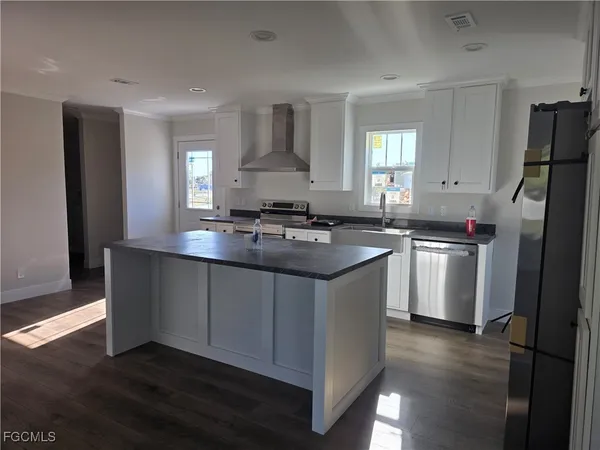 a kitchen with a sink stove and refrigerator