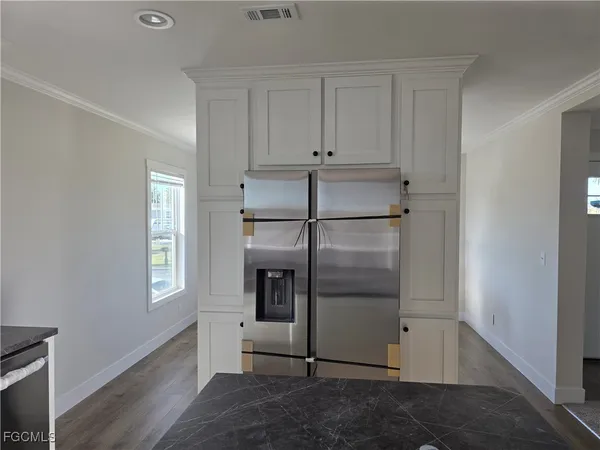 a kitchen with a refrigerator and window