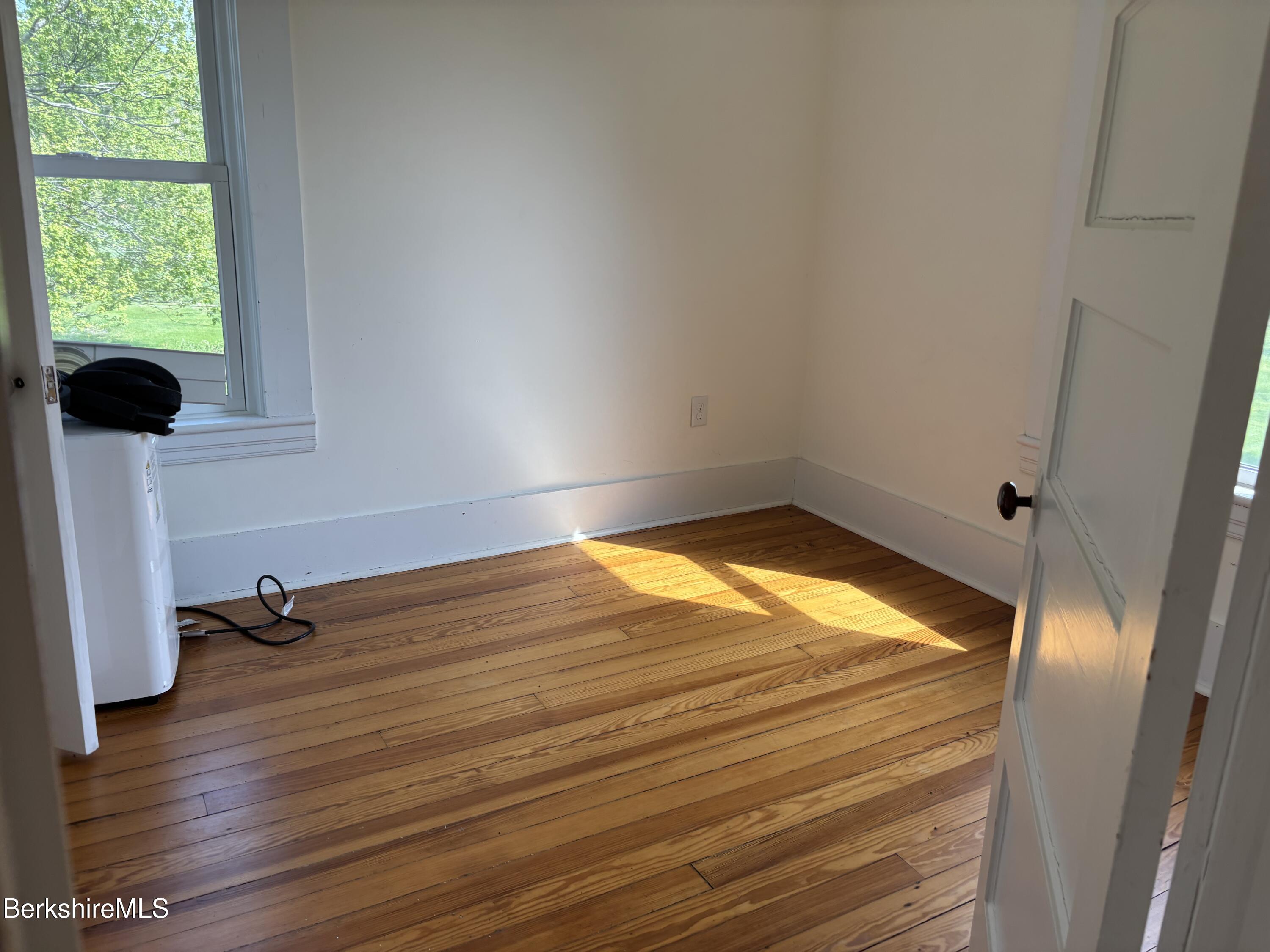 86 Miner Road Lanesborough, MA 01237 - Photo 38 of 44 a view of empty room with wooden floor and fan