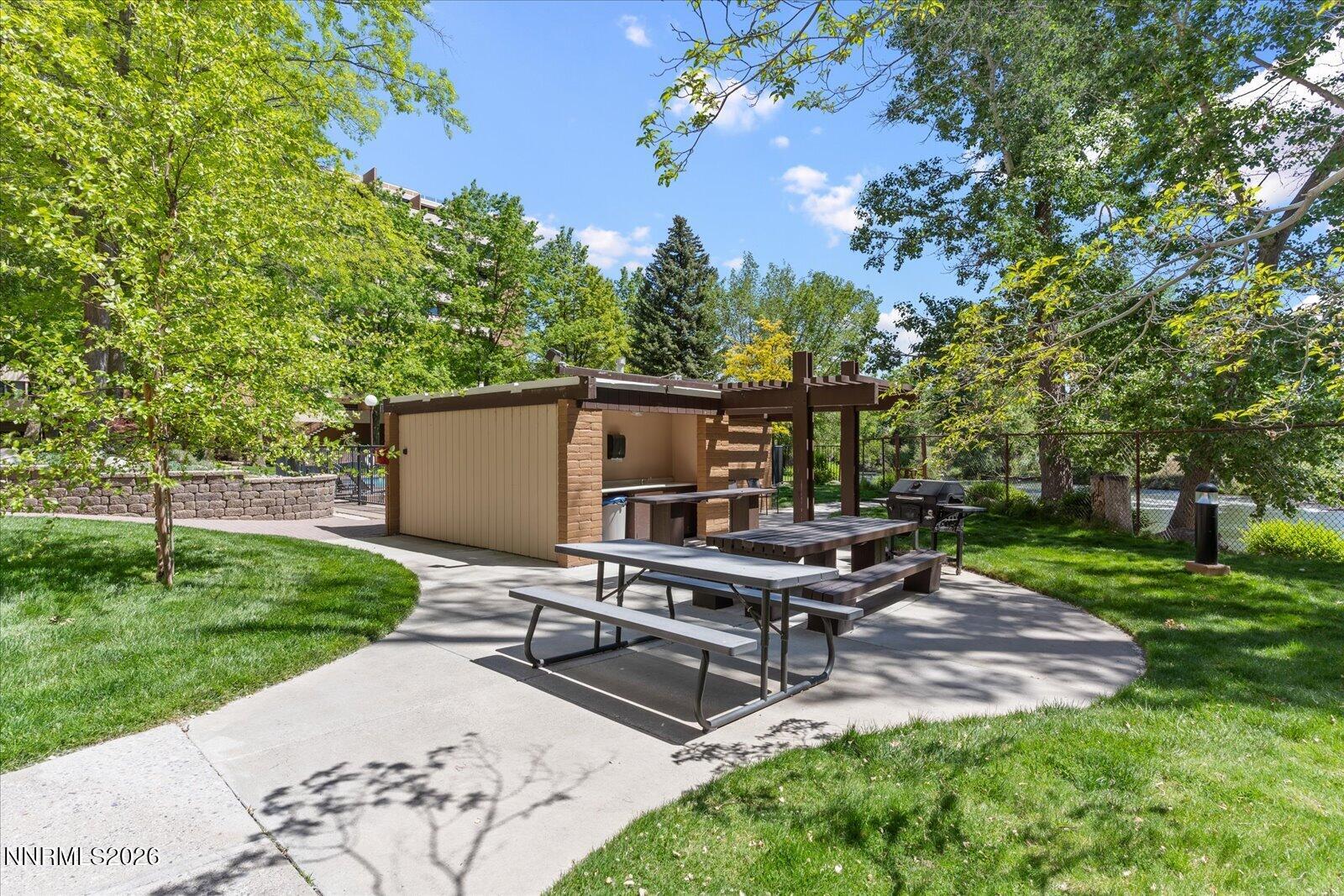 1200 Riverside Drive, Unit 1229 Reno, NV 89503 - Photo 47 of 51 a view of a backyard with wooden fence and a bench