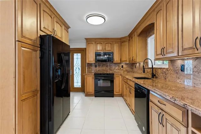 a view of a room with wooden floor and a ceiling fan