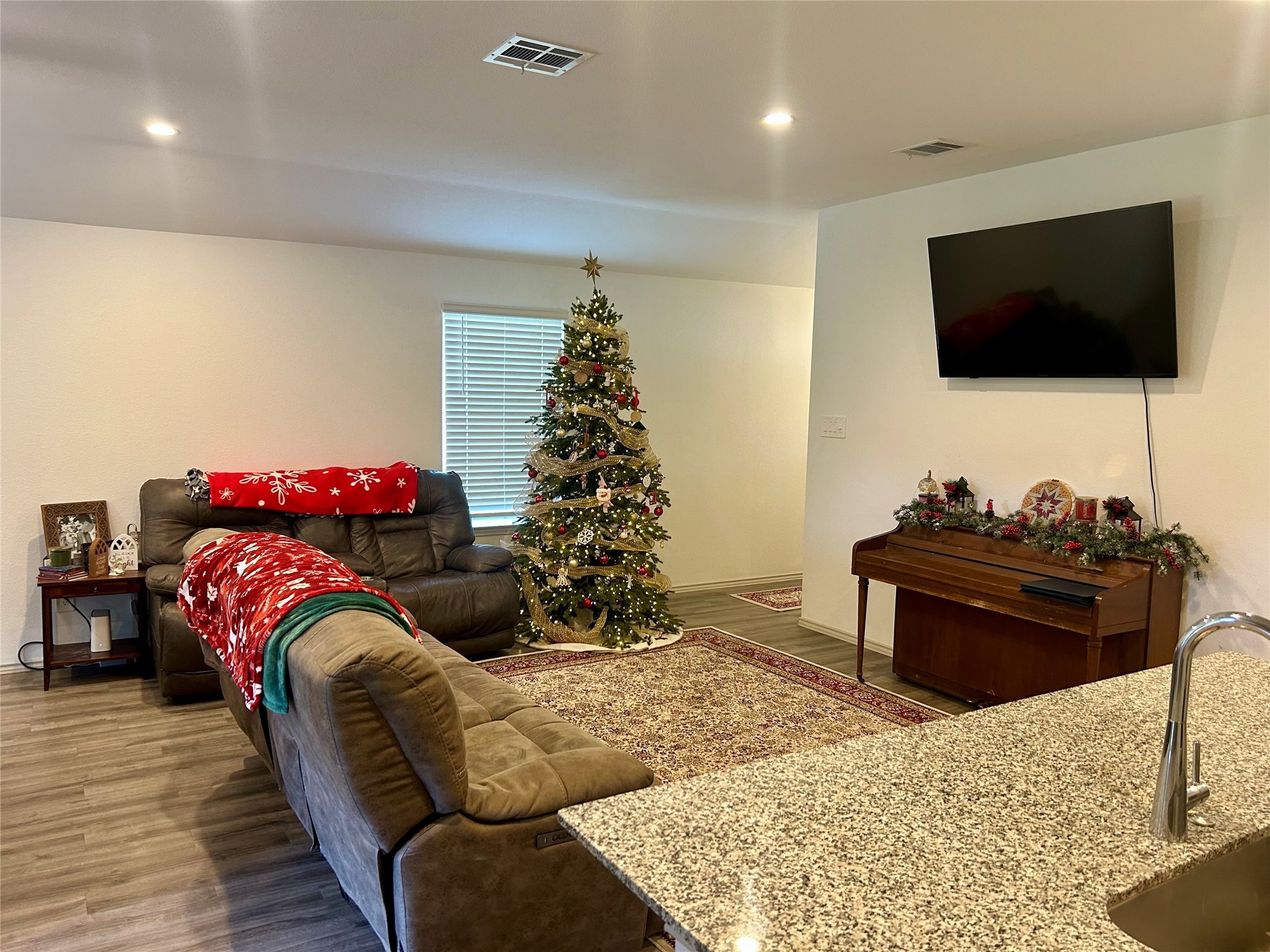 6515 Alexis Street Beaumont, TX 77708 - Photo 14 of 36 a living room with furniture a flat screen tv and a potted plant