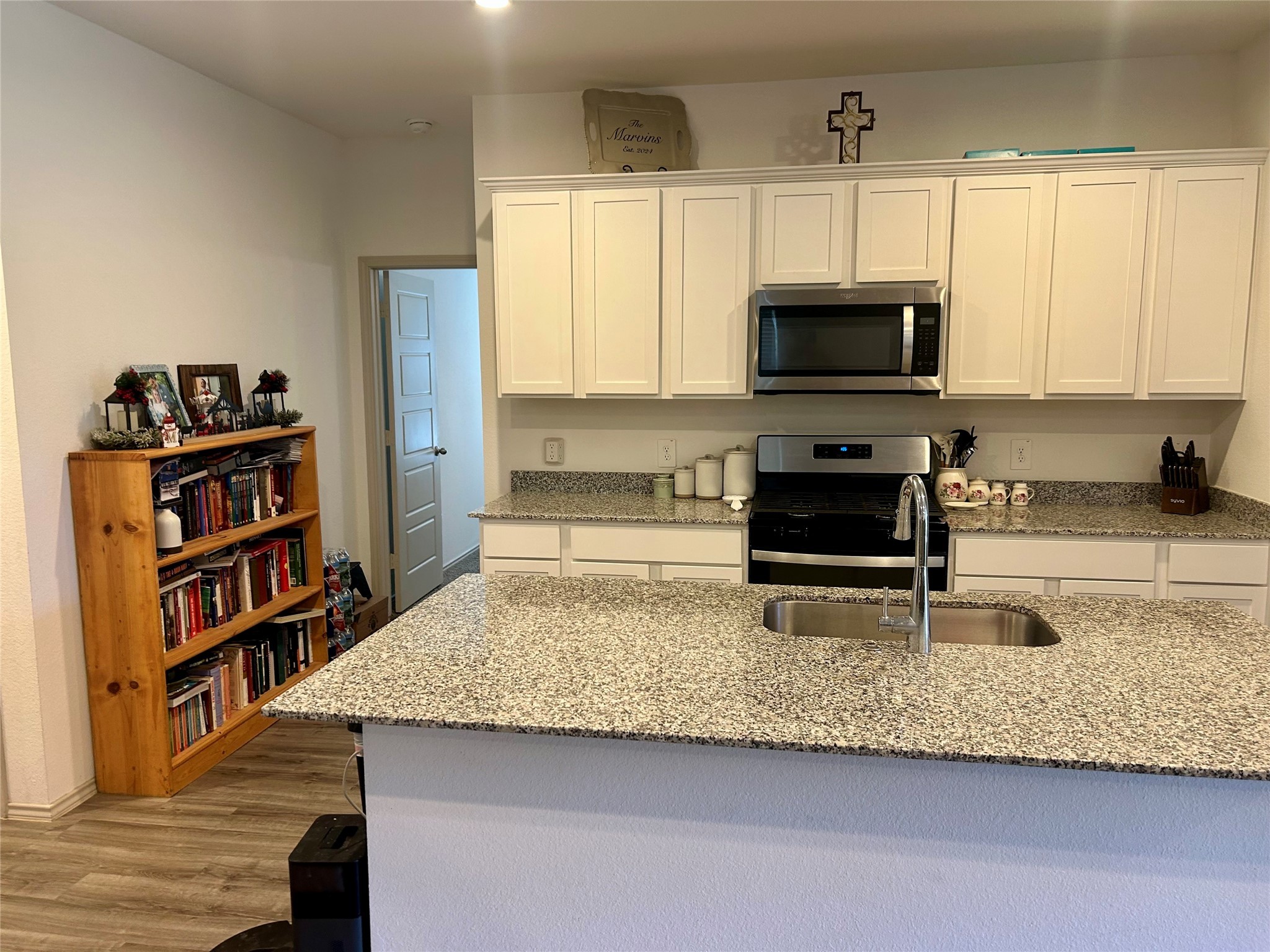 6515 Alexis Street Beaumont, TX 77708 - Photo 17 of 36 a kitchen with stainless steel appliances granite countertop a stove a sink and a microwave
