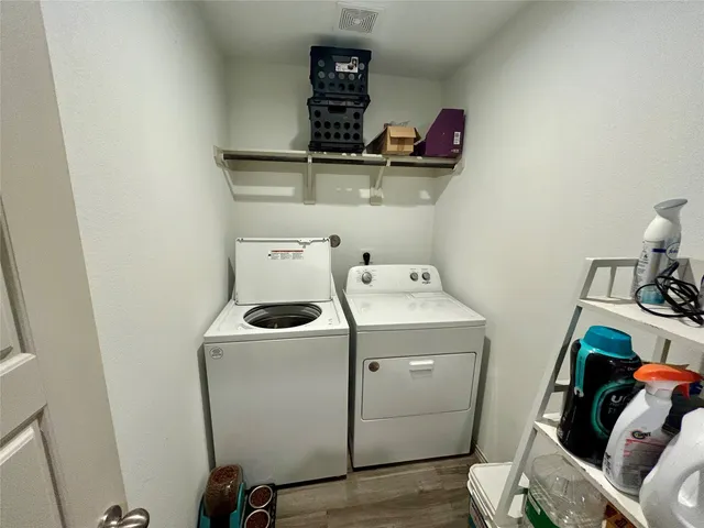 a view of storage and utility room with washer and dryer