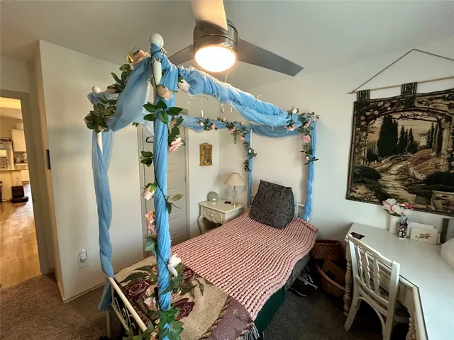 a view of a hallway with wooden floor and living room