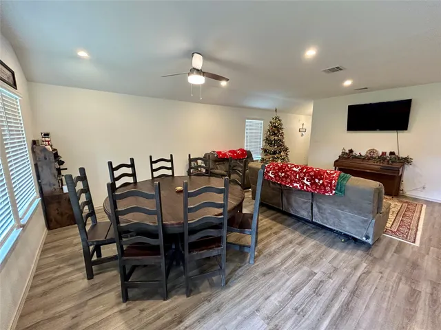 a view of a dining room with furniture and a chandelier