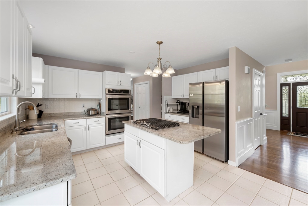 203 Richie Road Attleboro, MA 02703 - Photo 12 of 42 a kitchen with stainless steel appliances granite countertop a stove top oven a refrigerator a sink and dishwasher
