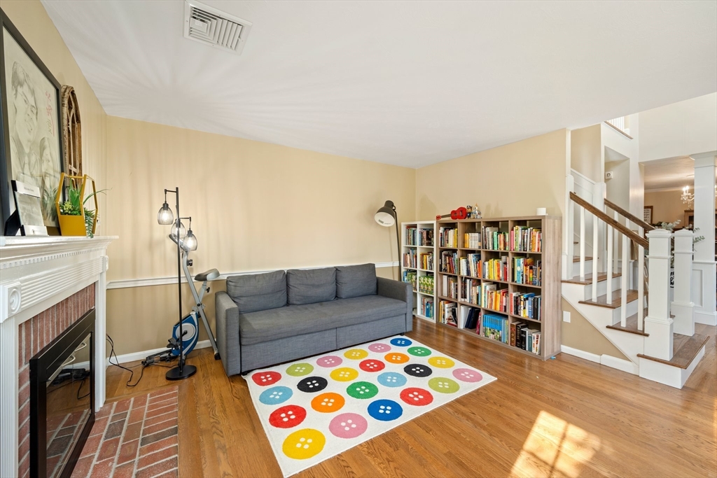 203 Richie Road Attleboro, MA 02703 - Photo 18 of 42 a living room with fireplace furniture and a book shelf