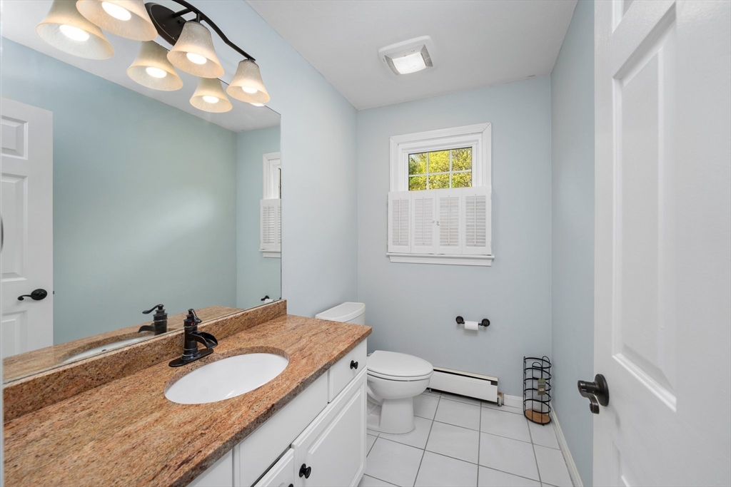 203 Richie Road Attleboro, MA 02703 - Photo 19 of 42 a bathroom with a granite countertop sink and a mirror