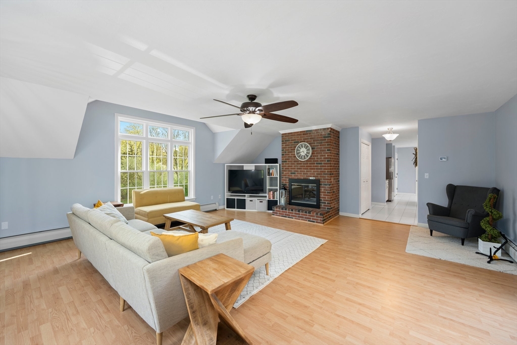 203 Richie Road Attleboro, MA 02703 - Photo 21 of 42 a living room with furniture a fireplace and a flat screen tv