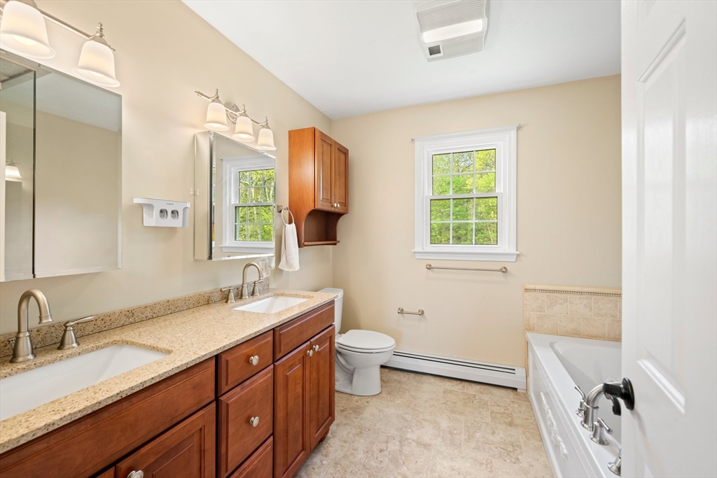 203 Richie Road Attleboro, MA 02703 - Photo 26 of 42 a bathroom with a double vanity sink toilet and a mirror