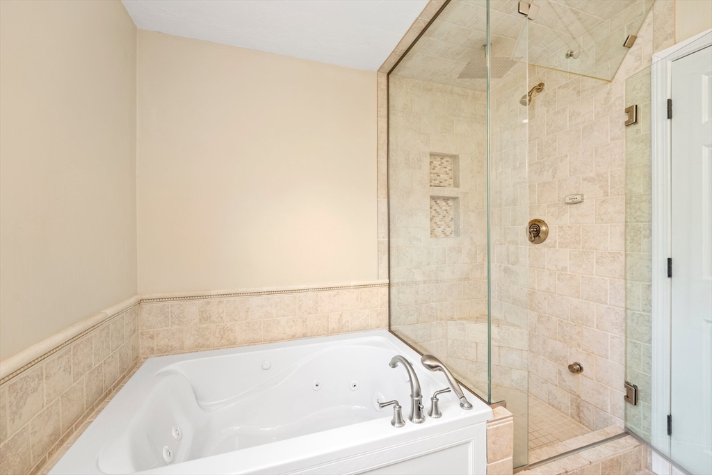 203 Richie Road Attleboro, MA 02703 - Photo 27 of 42 a white bath tub sitting next to a shower