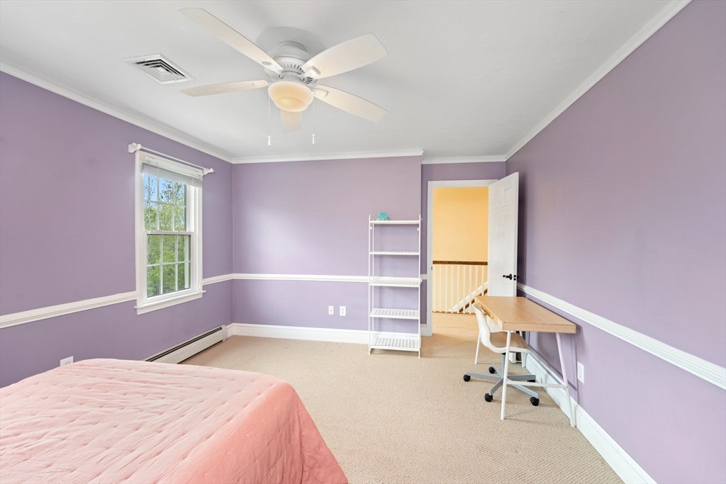 203 Richie Road Attleboro, MA 02703 - Photo 29 of 42 a bedroom with a bed a chandelier and a window