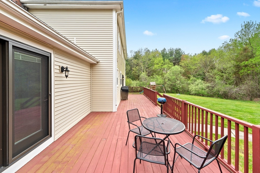 203 Richie Road Attleboro, MA 02703 - Photo 35 of 42 a view of a chair and table on the wooden deck