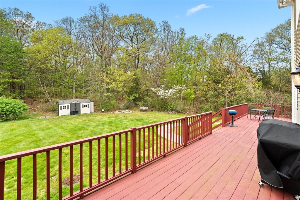 203 Richie Road Attleboro, MA 02703 - Photo 37 of 42 a balcony with wooden floor and yard in the back